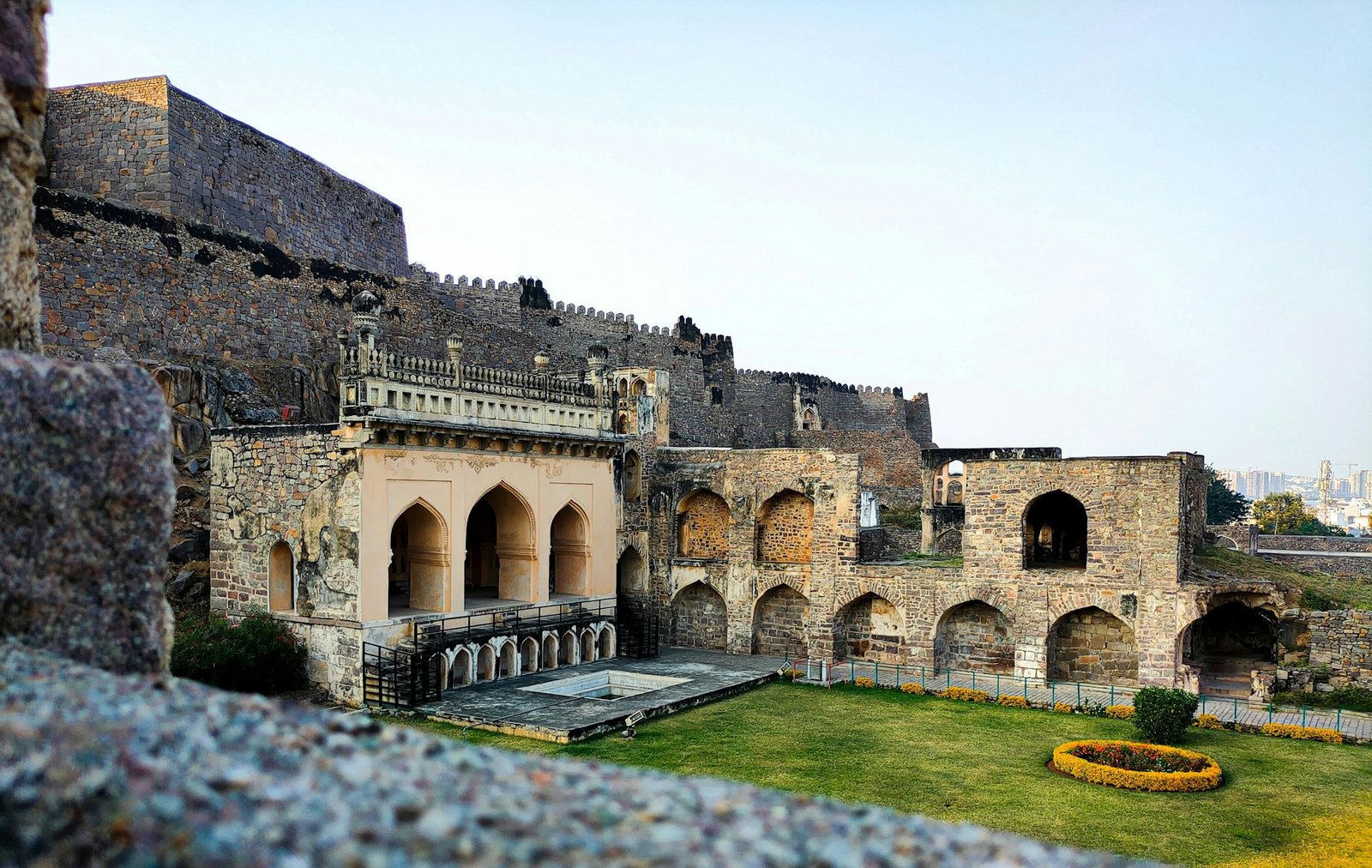 Granite bastions of Golconda Fort under a warm evening sky